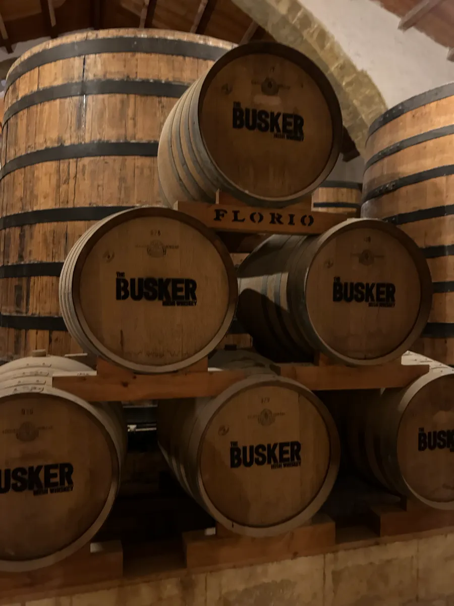 Rows of wooden barrels aging Marsala wine in historic Florio cellars, Sicily’s renowned fortified wine producer
